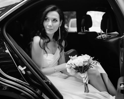 pretty-young-bride-looking-out-car